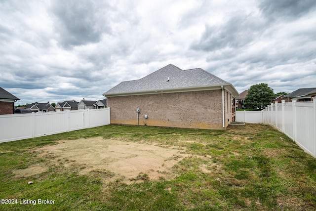 back of house with a yard