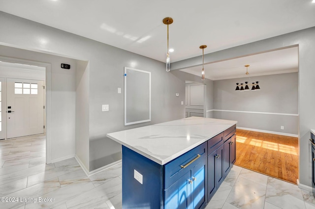 kitchen with a center island, hanging light fixtures, light hardwood / wood-style flooring, blue cabinetry, and light stone counters