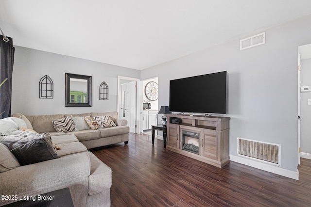 living room featuring dark wood-type flooring