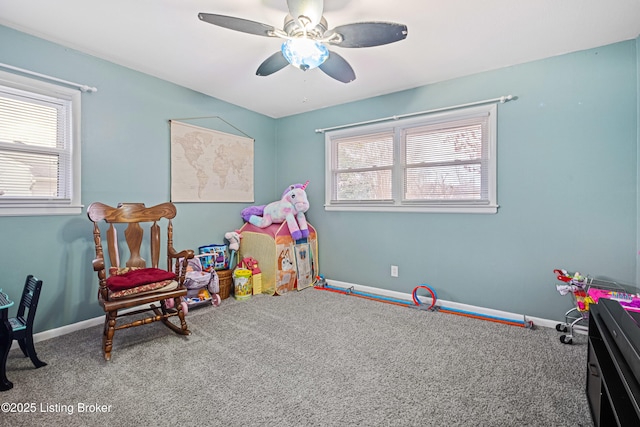 game room with carpet flooring and ceiling fan