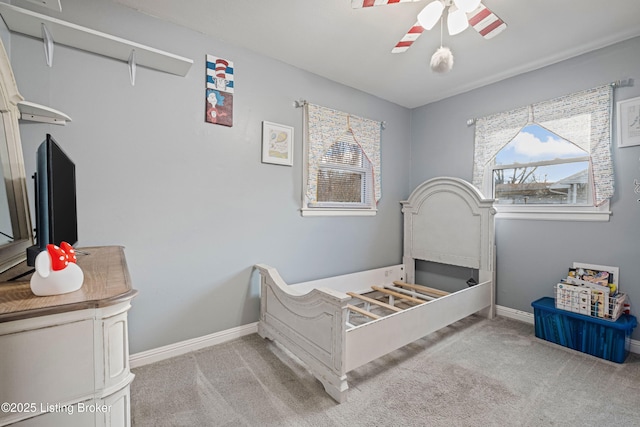 bedroom with ceiling fan and light carpet