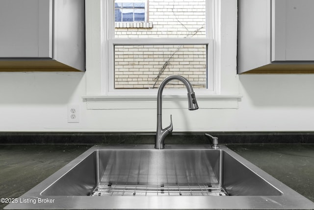 interior details with gray cabinetry and a sink