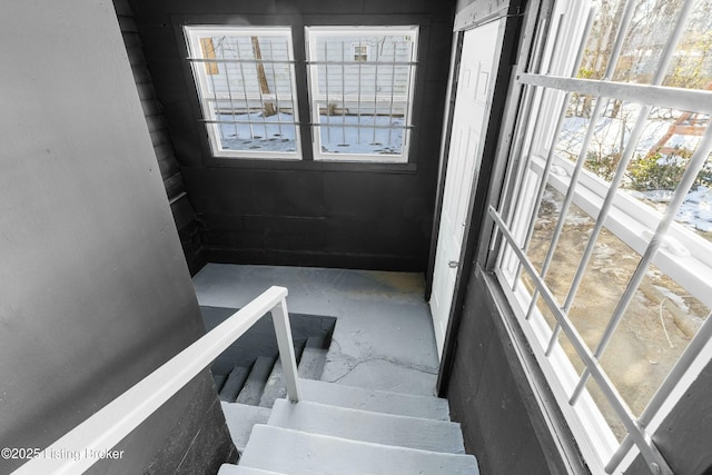 stairway featuring concrete floors