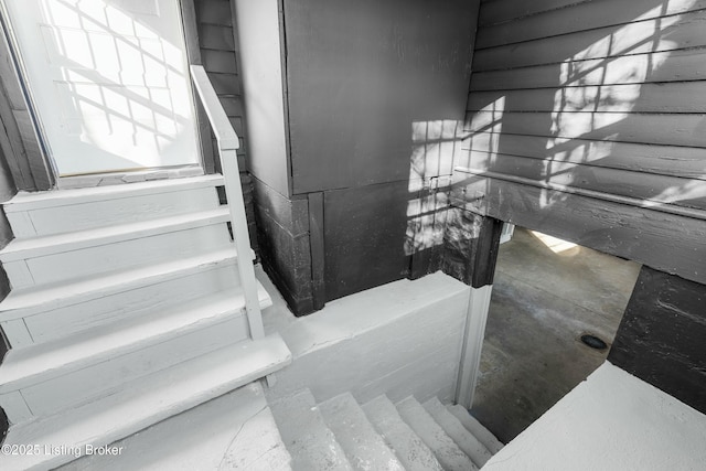 stairs with concrete flooring