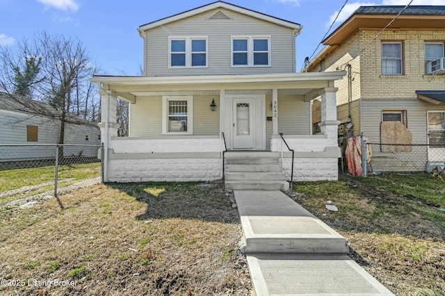 view of front of home with covered porch and fence