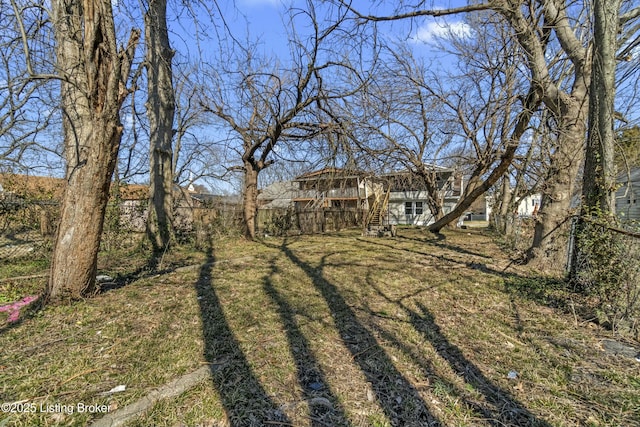 view of yard with stairway and fence