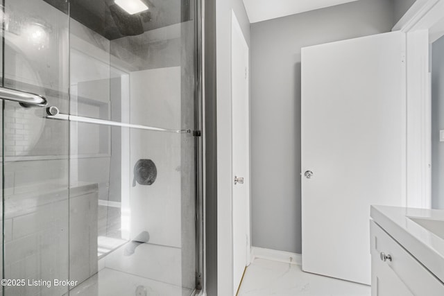 bathroom featuring vanity and a shower with door