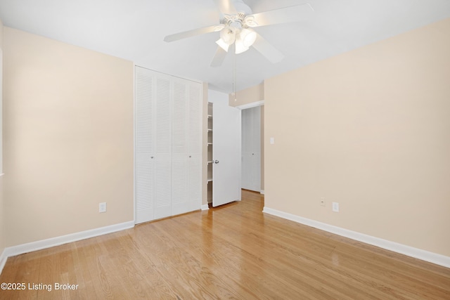 empty room with ceiling fan and light hardwood / wood-style flooring