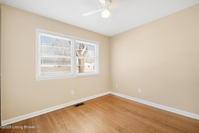 empty room featuring hardwood / wood-style flooring and ceiling fan