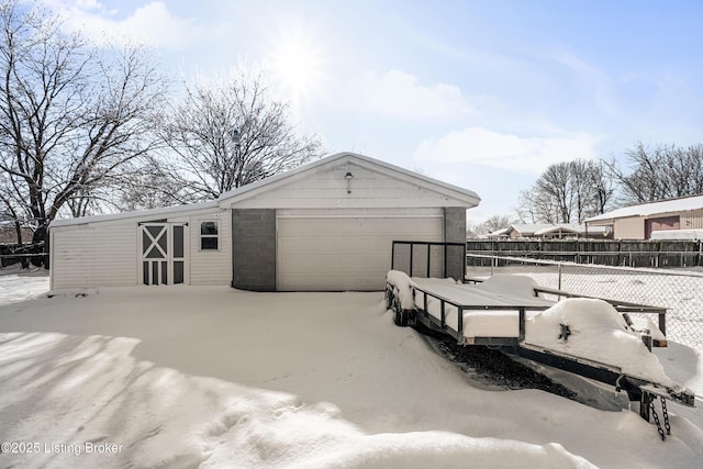 exterior space featuring a garage and an outbuilding