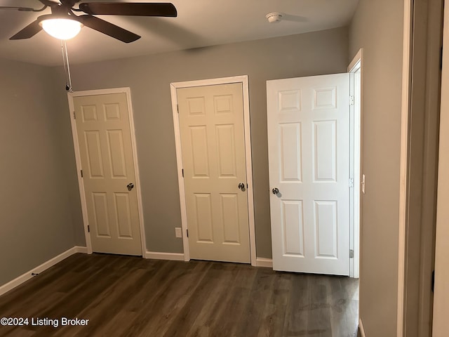 unfurnished bedroom featuring ceiling fan and dark hardwood / wood-style flooring