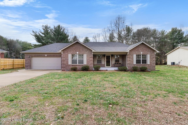 ranch-style house with covered porch, a garage, and a front yard