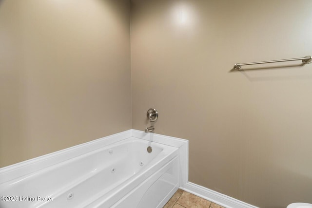 bathroom with tile patterned flooring and a washtub