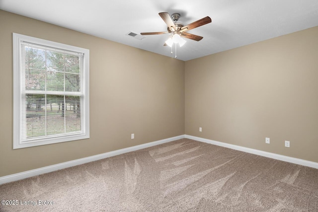 carpeted empty room featuring ceiling fan