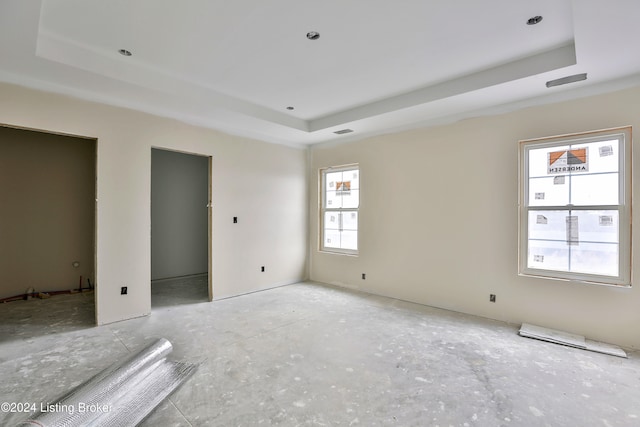 unfurnished bedroom featuring a raised ceiling