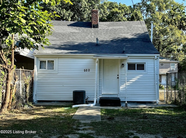 rear view of house featuring central AC unit