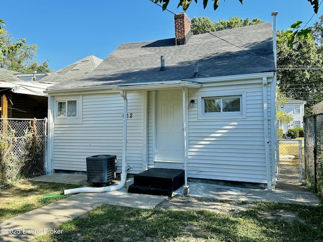 back of property featuring central AC