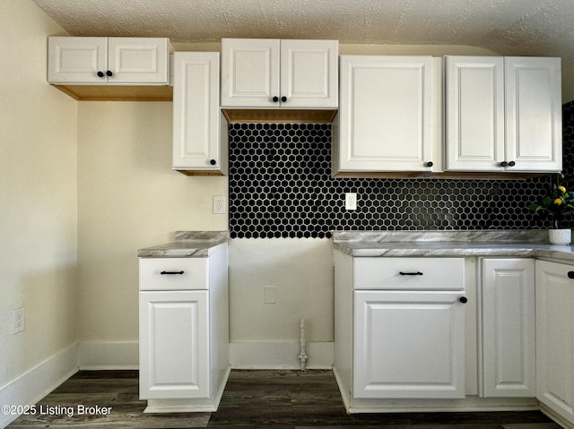 kitchen featuring white cabinetry and dark hardwood / wood-style flooring