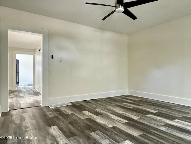 unfurnished room with ceiling fan and dark hardwood / wood-style flooring