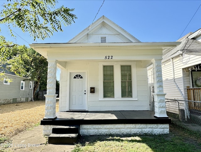 view of exterior entry featuring covered porch