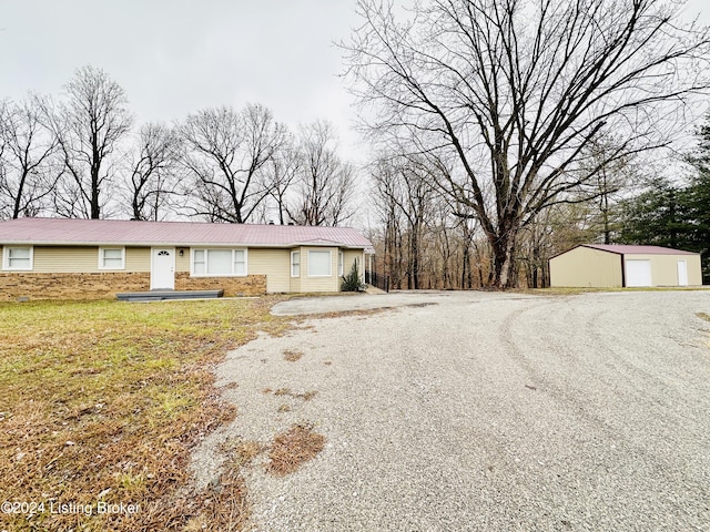 view of front of house with an outbuilding, a garage, and a front yard