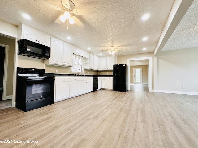 kitchen featuring white cabinetry, sink, a textured ceiling, black appliances, and light wood-type flooring