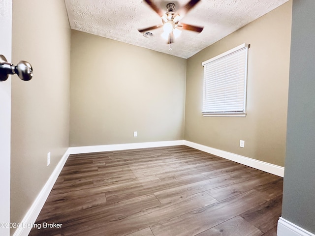 unfurnished room featuring ceiling fan, hardwood / wood-style floors, and a textured ceiling