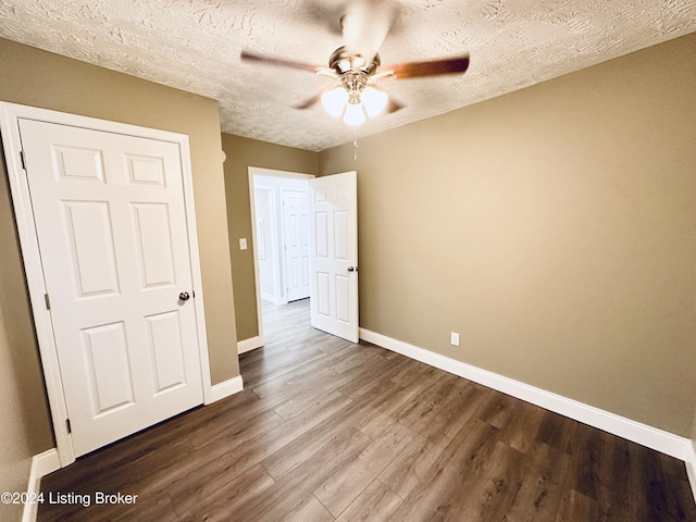 unfurnished bedroom with ceiling fan, hardwood / wood-style floors, and a textured ceiling