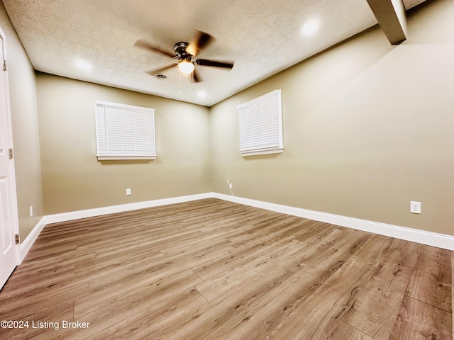 unfurnished room featuring ceiling fan, a textured ceiling, and light hardwood / wood-style flooring