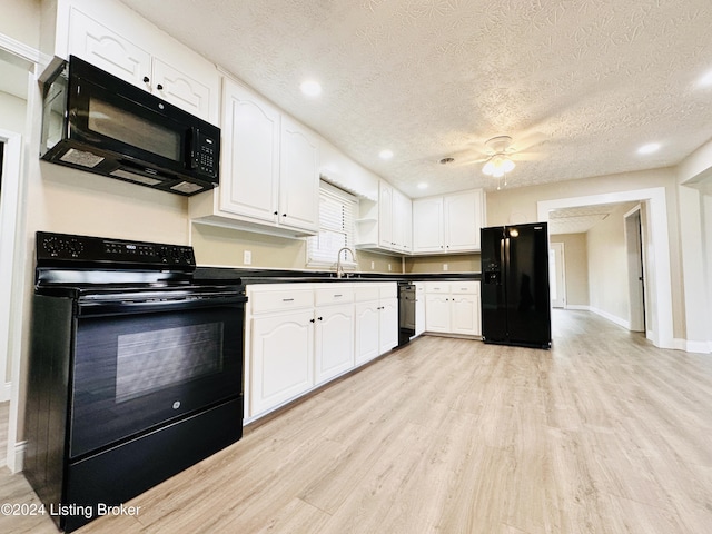 kitchen featuring sink, light hardwood / wood-style flooring, a textured ceiling, white cabinets, and black appliances