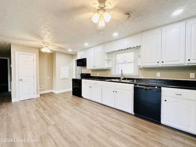 kitchen with sink, white cabinets, black appliances, and a textured ceiling