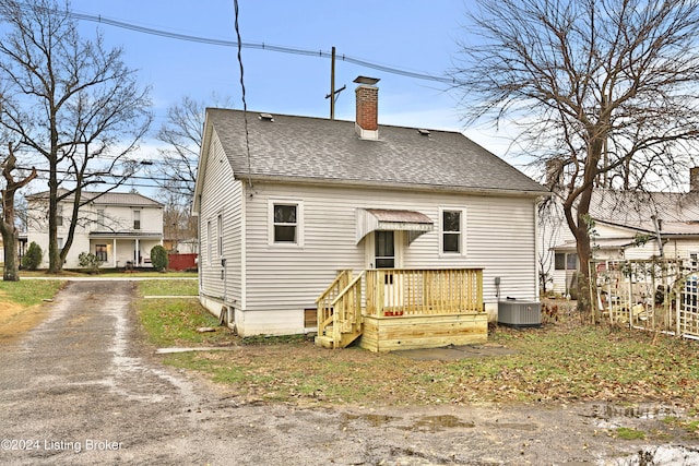 back of house with central AC unit