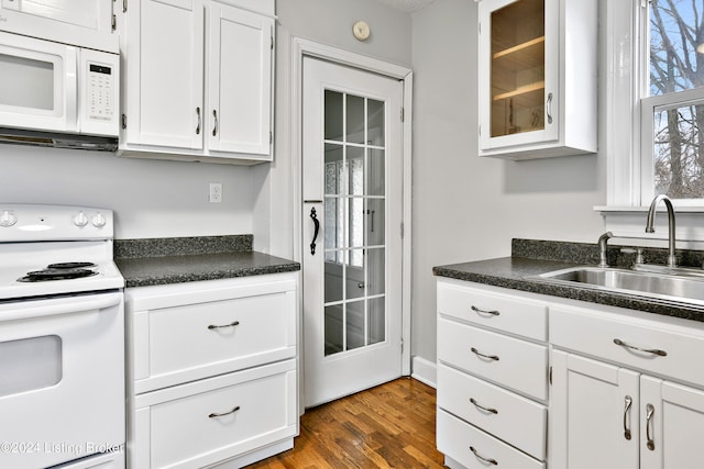 kitchen featuring white cabinets, dark hardwood / wood-style floors, white appliances, and sink