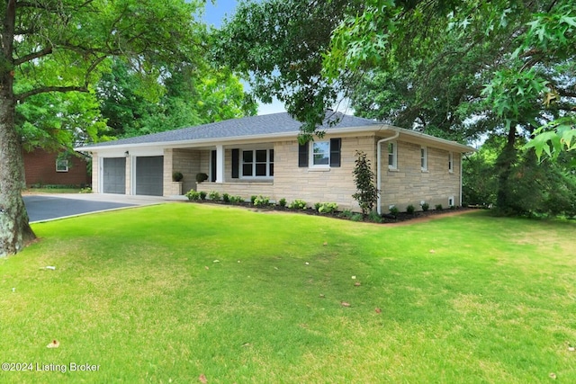 ranch-style home with a garage and a front lawn