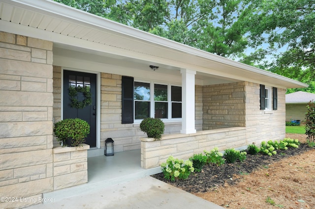 view of exterior entry featuring a porch