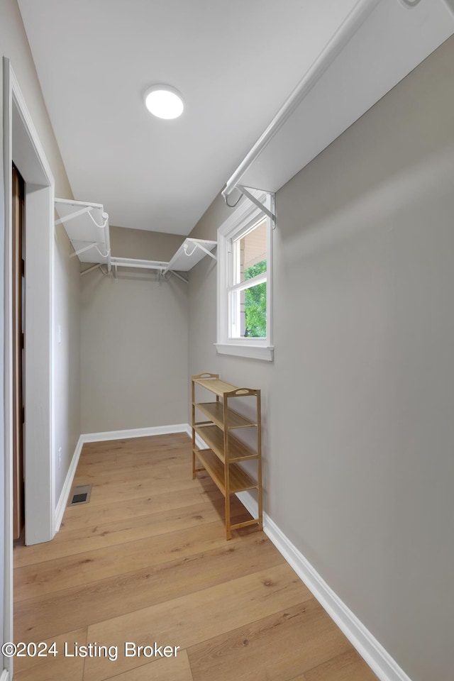 spacious closet with light hardwood / wood-style floors