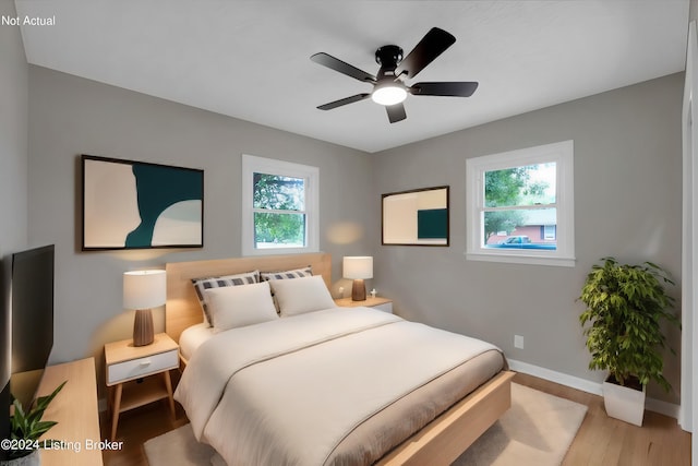 bedroom with ceiling fan and light hardwood / wood-style flooring