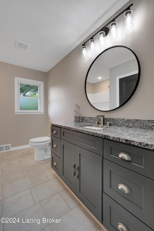 bathroom featuring vanity and toilet