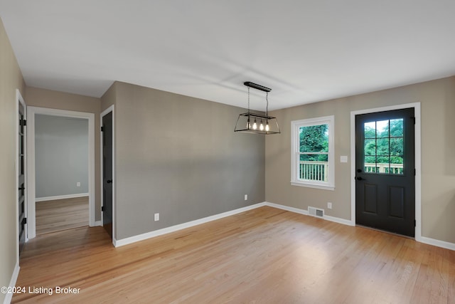 interior space featuring a notable chandelier and light hardwood / wood-style flooring