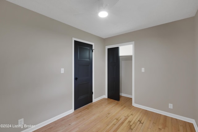 unfurnished bedroom featuring ceiling fan and light wood-type flooring