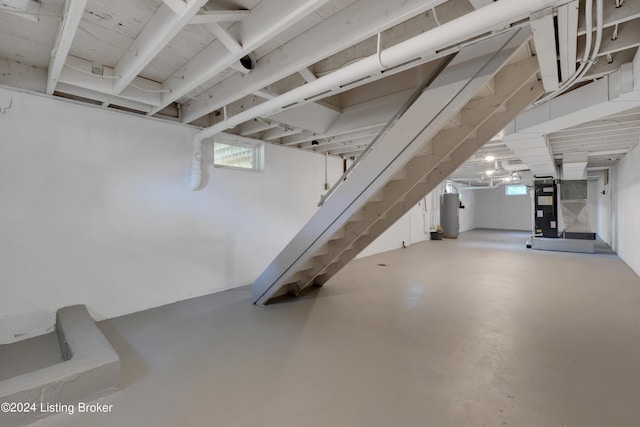 basement featuring water heater and heating unit