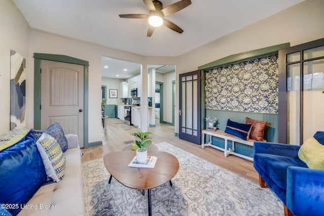 living room featuring ceiling fan and light hardwood / wood-style flooring