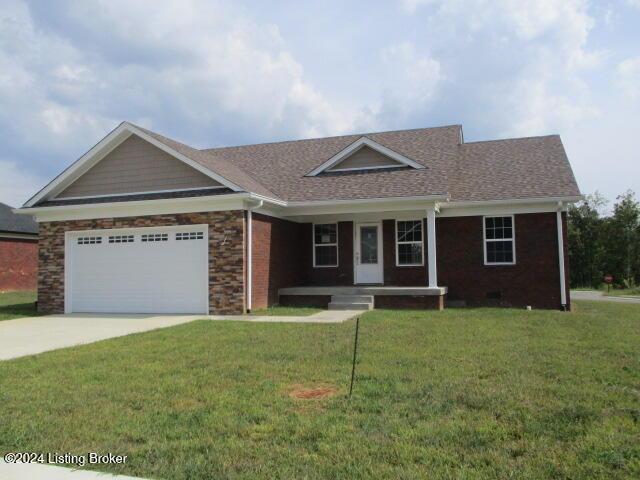 single story home with a garage and a front lawn