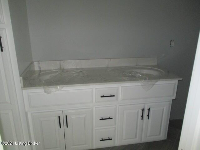 bathroom with tile patterned flooring and vanity