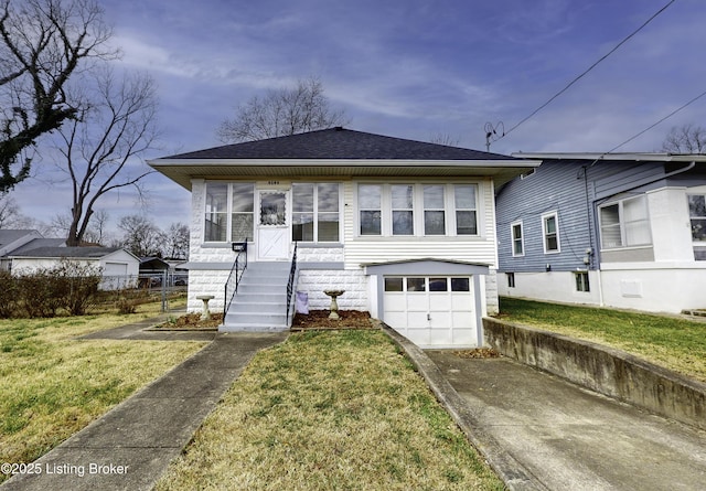 view of front of property featuring a garage and a front lawn