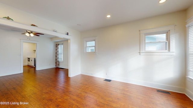 empty room featuring ceiling fan and dark wood-type flooring