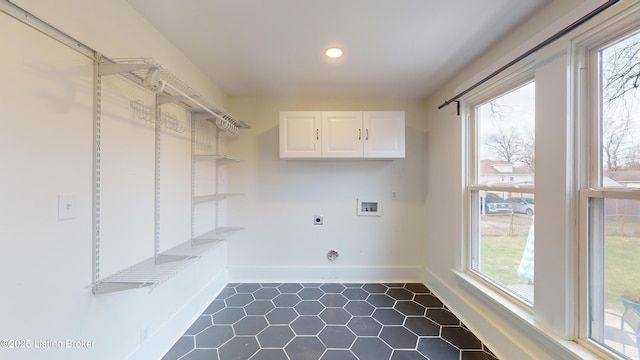 laundry room featuring electric dryer hookup, cabinets, and washer hookup