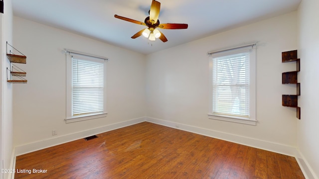 empty room with hardwood / wood-style floors and ceiling fan