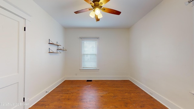 spare room featuring ceiling fan and hardwood / wood-style flooring