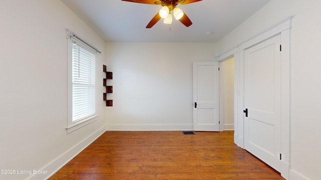 spare room with wood-type flooring and ceiling fan